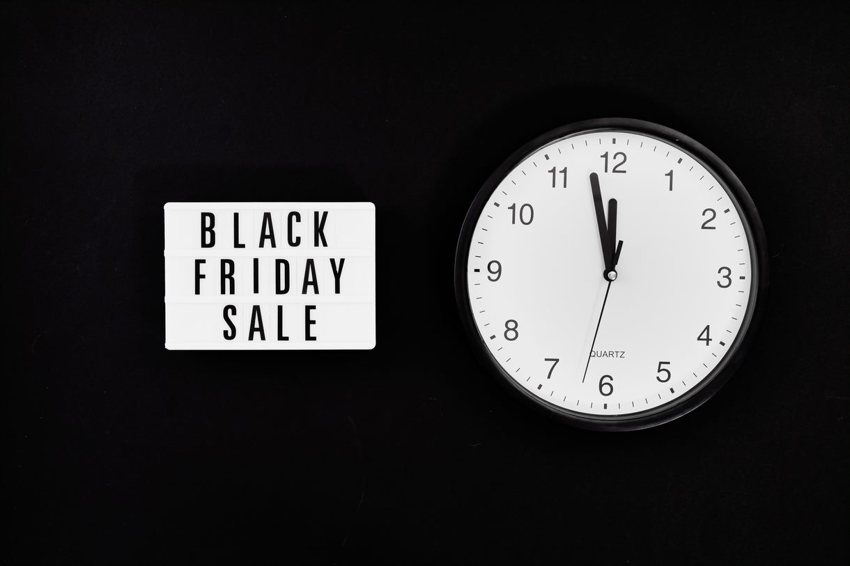 sign that reads "Black Friday Sale" next to a clock