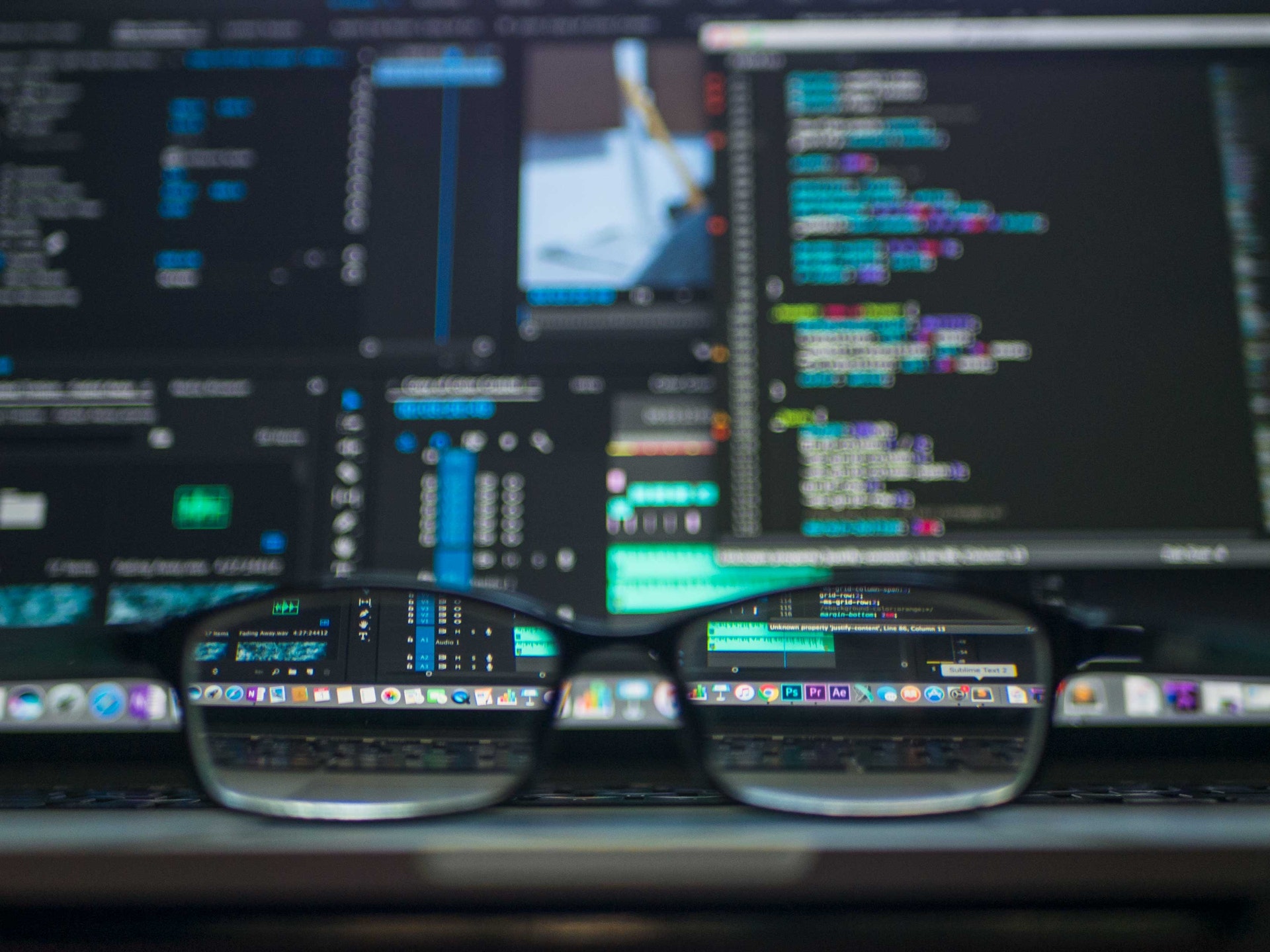 eye glasses in front of a computer screen displaying code