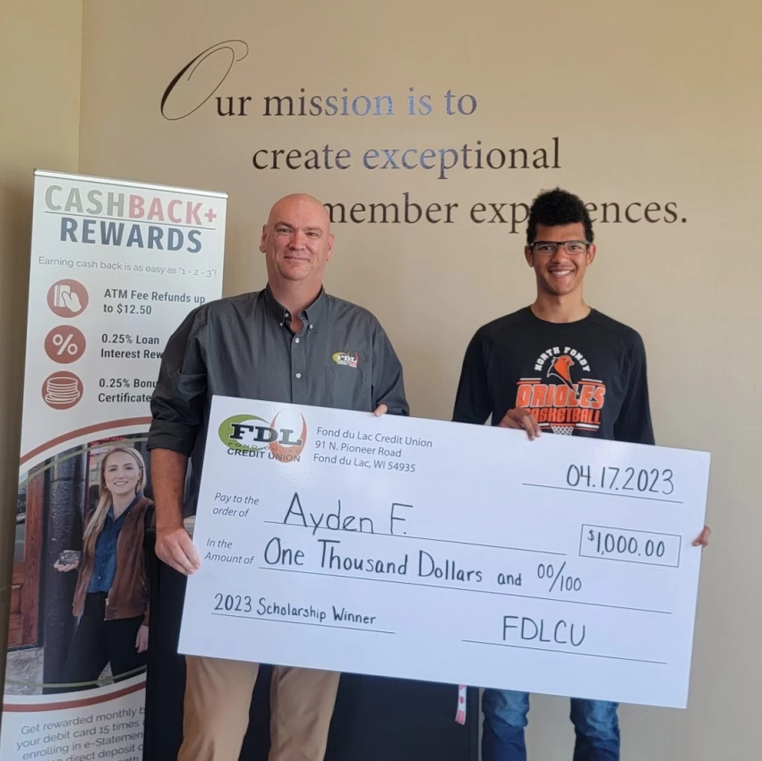 2023 Scholarship Winner holding giant check