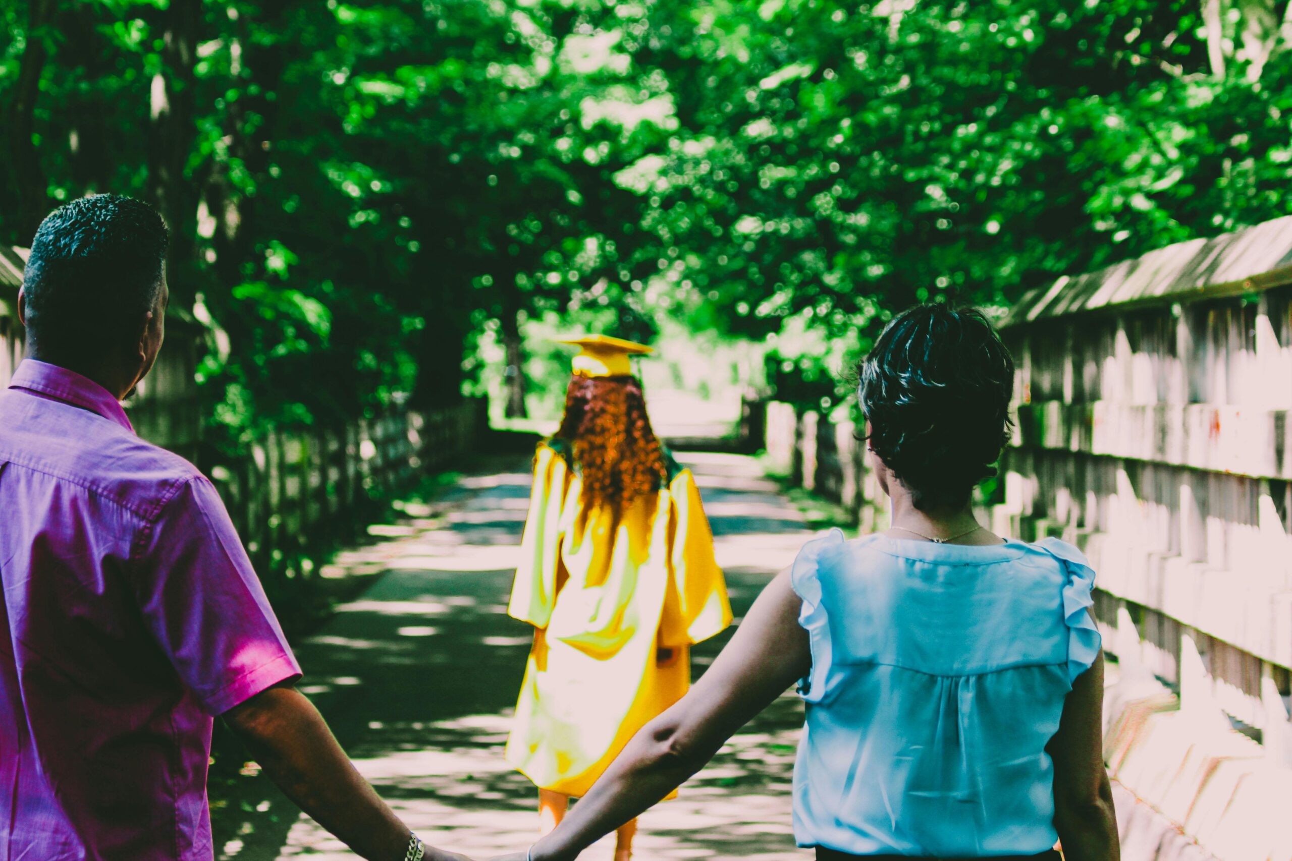 Parent and child holding walks while strolling in the park